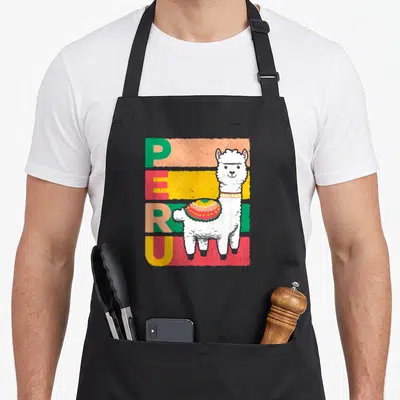 Sweet peruvian apron - Cartoon llama with decorative blanket standing near vertical PERU text over colored stripes — shown on a black cotton canvas apron against a white background