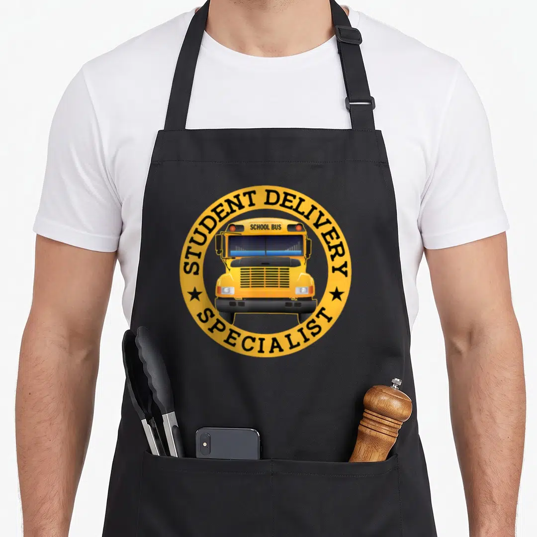 Delivery student aprons - Yellow school bus in circle with STUDENT DELIVERY SPECIALIST text and two stars — shown on a black cotton canvas apron against a white background