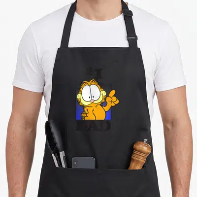 Cute number father day apron - Garfield in blue square with #1 DAD text pointing up — shown on a black cotton canvas apron against a white background