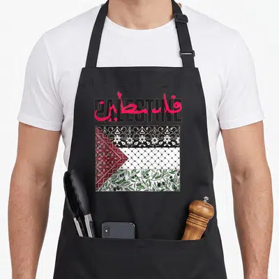 Gaza flag palestine apron - PALESTINE text overlapped by red Arabic script above flag pattern with olive branches — shown on a black cotton canvas apron against a white background