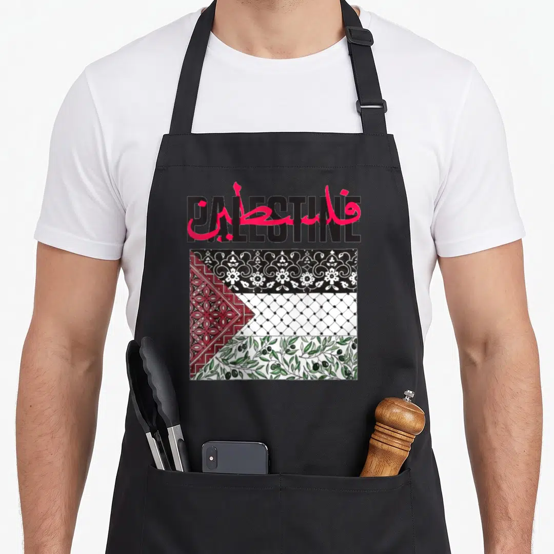 Gaza flag palestine apron - PALESTINE text overlapped by red Arabic script above flag pattern with olive branches — shown on a black cotton canvas apron against a white background