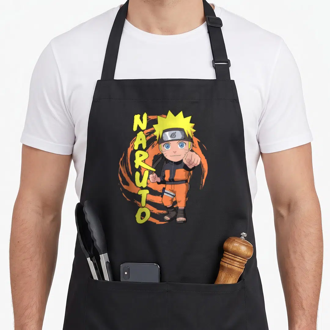 Chibi anime apron - Vertical NARUTO text beside a pointing chibi character in orange gear against a swirl background — shown on a black cotton canvas apron against a white background