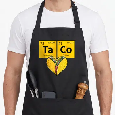 Taco table apron - Two yellow periodic table squares above heart-shaped tacos in cartoon style — shown on a black cotton canvas apron against a white background
