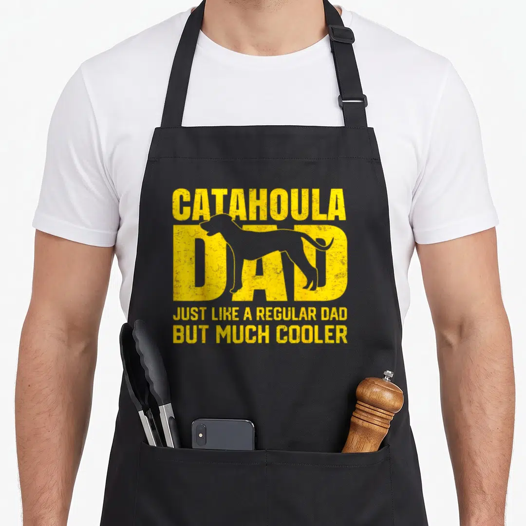 Parent leopard apron - Yellow distressed CATAHOULA DAD text with dog silhouette — shown on a black cotton canvas apron against a white background