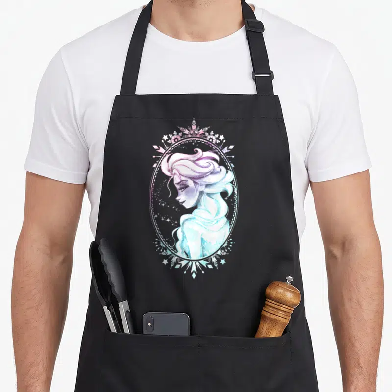 Glance winter apron - Watercolor woman in oval frame with purple blue gradient snowflakes stars — shown on a black cotton canvas apron against a white background