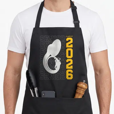 Sousaphone class player apron - White sousaphone silhouette with yellow 2026 and repeated Senior outline text — shown on a black cotton canvas apron against a white background