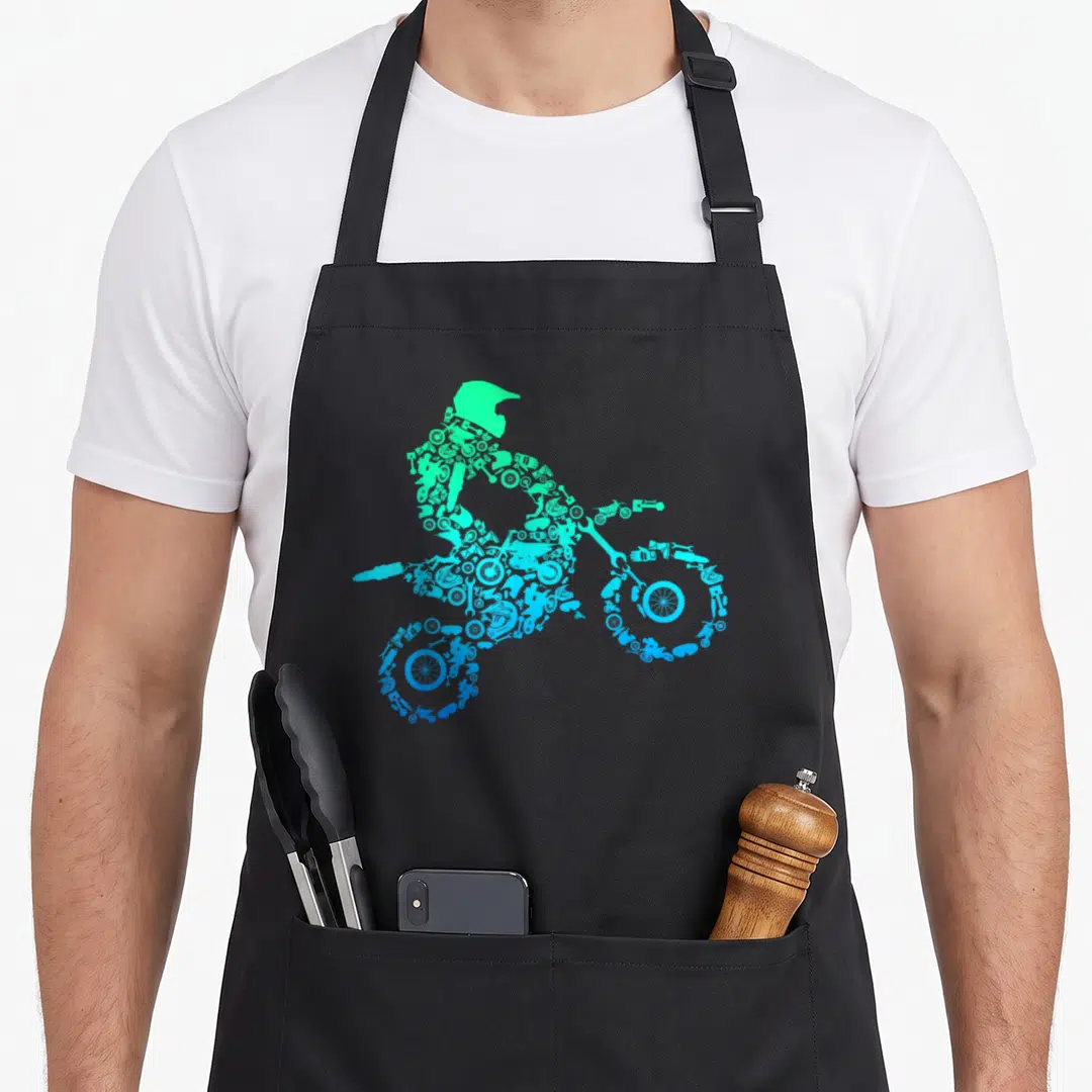 Rider bike apron - Green cyan blue silhouette of motocross rider formed by motorcycle parts and tools — shown on a black cotton canvas apron against a white background