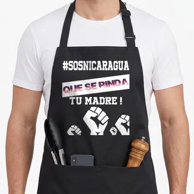 Libre nicaraguan girl apron - #SOSNICARAGUA text and four white fists on a banner in red and blue — shown on a black cotton canvas apron against a white background