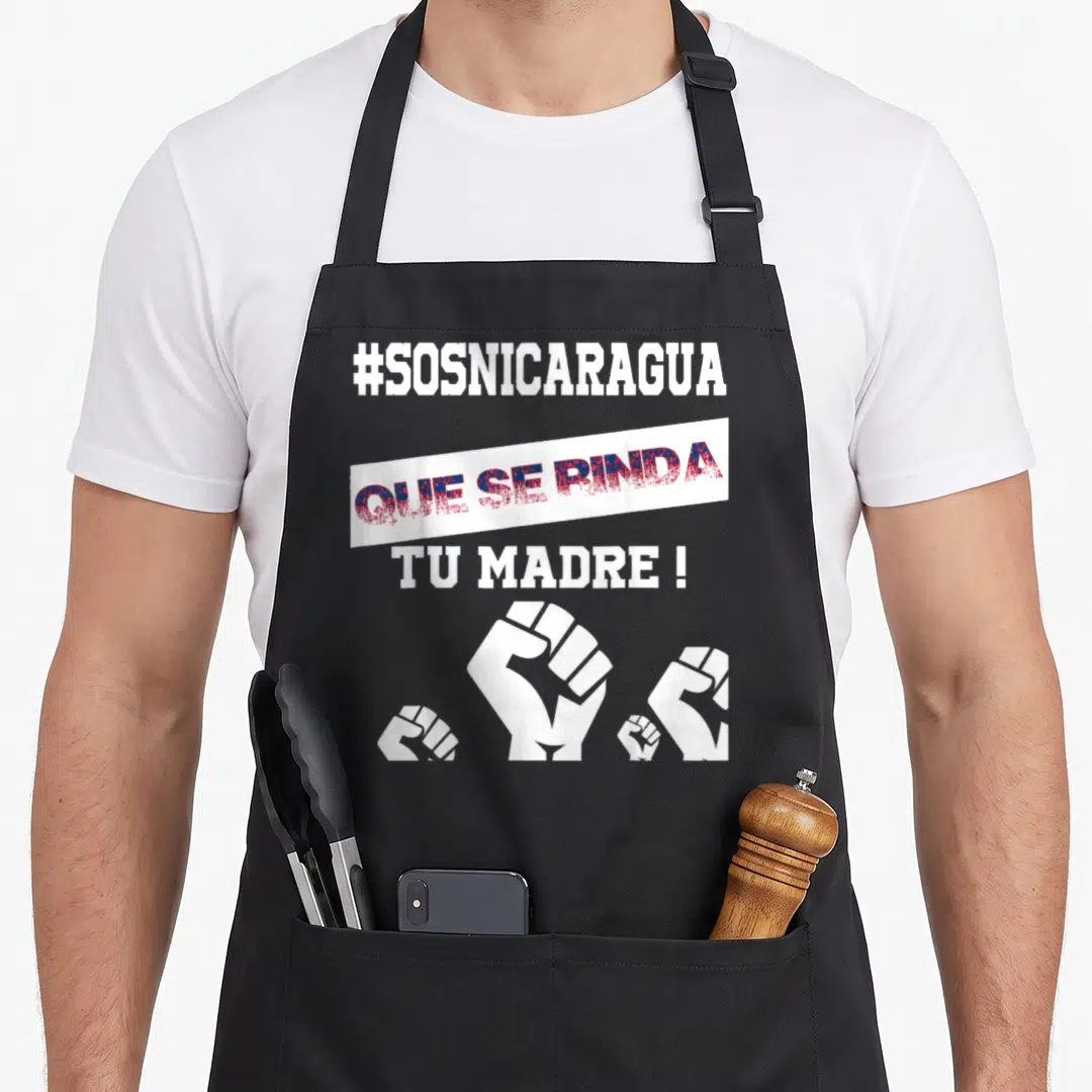 Libre nicaraguan girl apron - #SOSNICARAGUA text and four white fists on a banner in red and blue — shown on a black cotton canvas apron against a white background