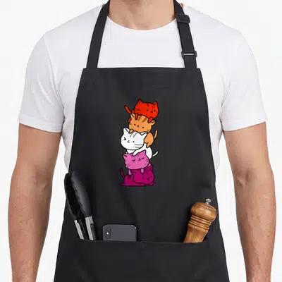 Lesbian kawaii apron - Five cartoon cats stacked vertically in red orange white pink and magenta — shown on a black cotton canvas apron against a white background