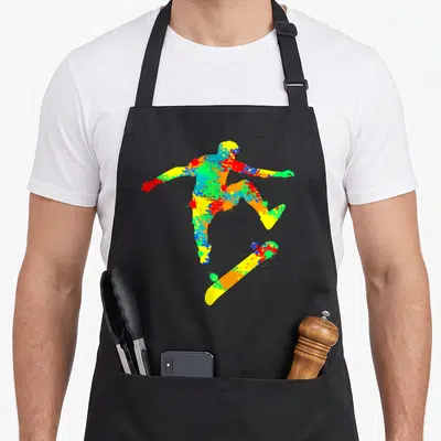 Skater stunt skateboard funny apron - Colorful paint splatter silhouette of a skateboarder in mid-air above a board — shown on a black cotton canvas apron against a white background