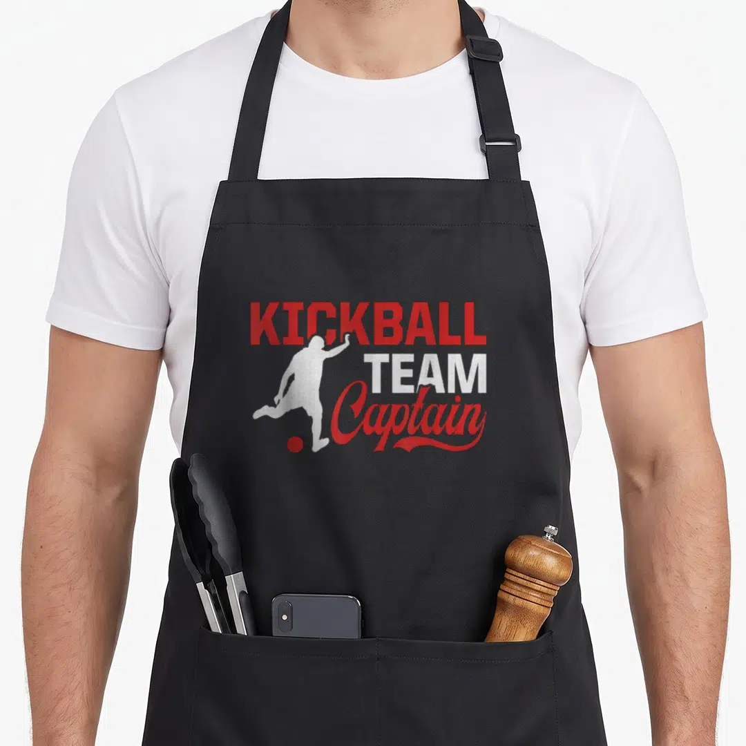 Player team captain apron - Red and white distressed graphic of a kicking player silhouette with stacked text reading — shown on a black cotton canvas apron against a white background