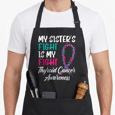 Sister fight thyroid apron - Stacked text reading My Sister's Fight Is My Fight Thyroid Cancer Awareness beside — shown on a black cotton canvas apron against a white background