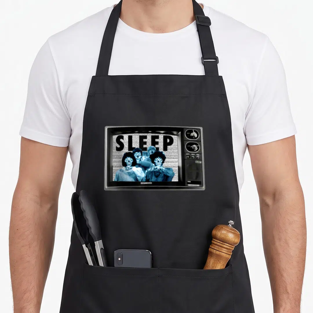 Our 1980s apron - Retro TV set with SLEEP text and blue skeletons on screen — shown on a black cotton canvas apron against a white background