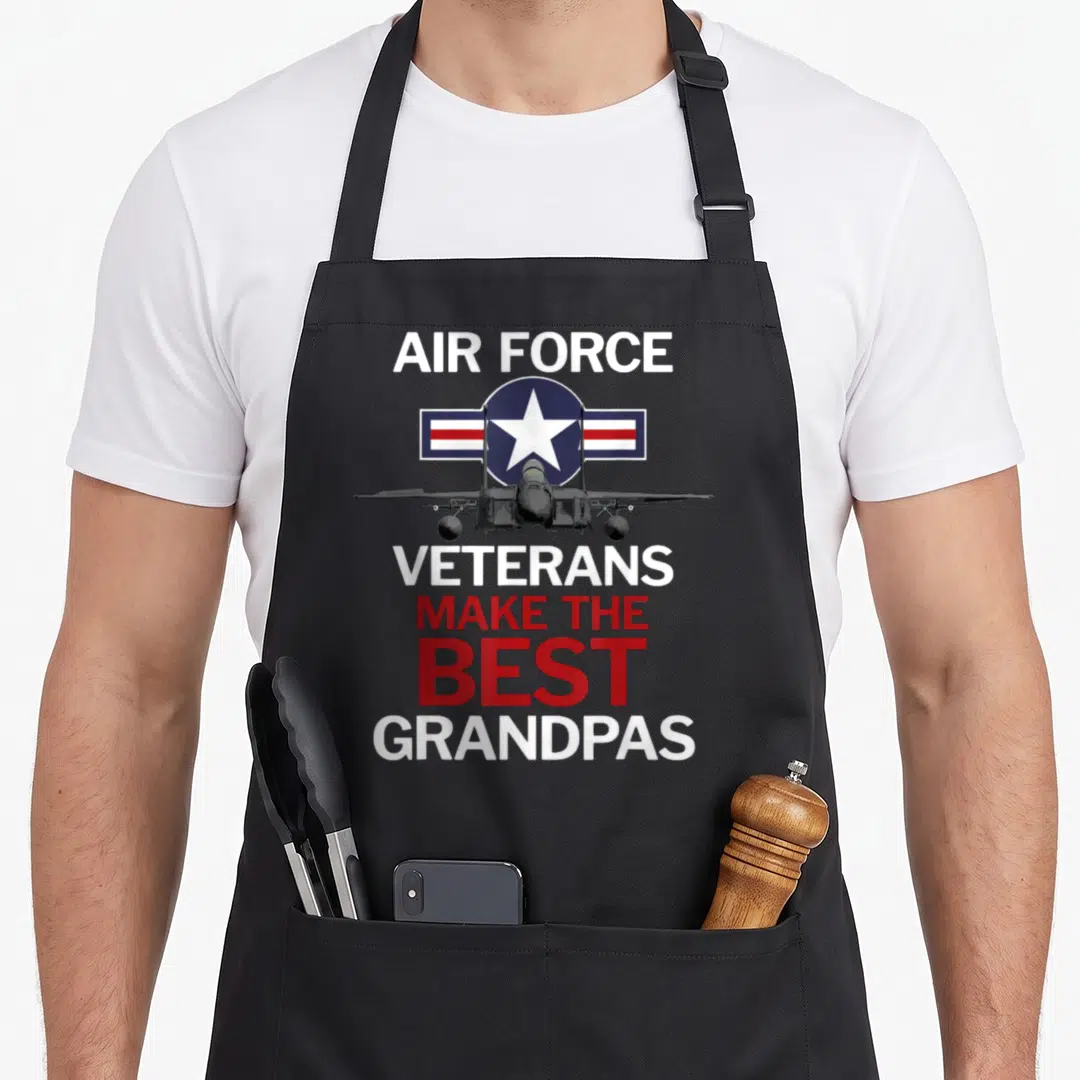 Grandpas zeewire air force veteran family apron - Grey jet plane in front of red white and blue roundel with text about — shown on a black cotton canvas apron against a white background