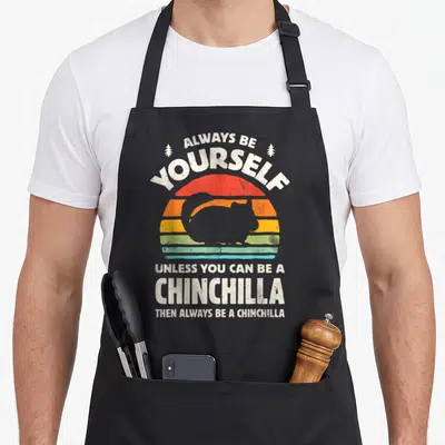 Alway crazy chinchilla man apron - Retro striped sunset with chinchilla silhouette and humorous rodent lover quote text — shown on a black cotton canvas apron against a white background