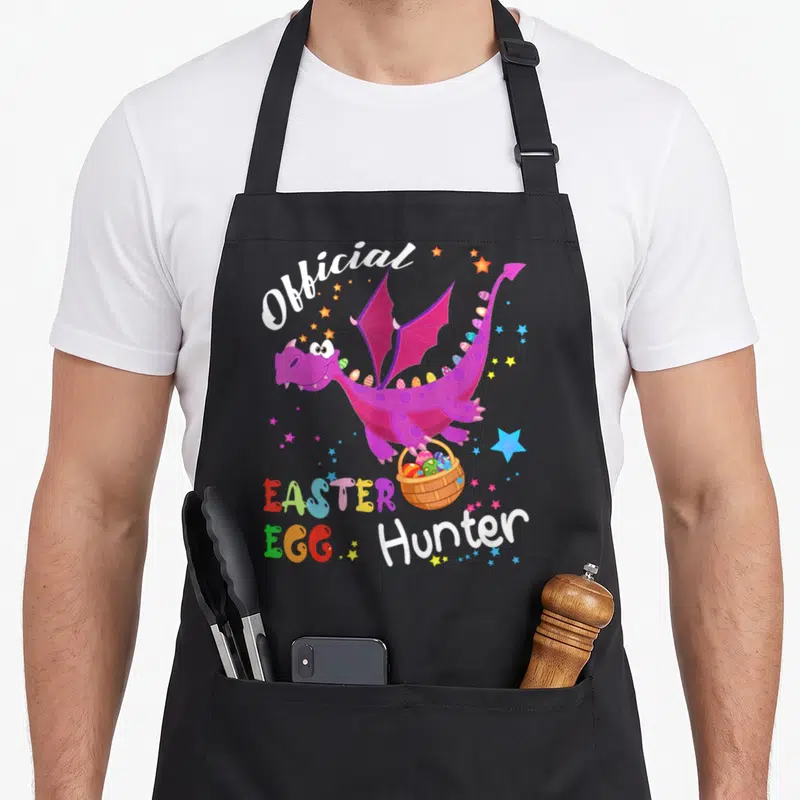 Holding basket apron - Purple dragon holding egg basket with Official Easter Egg Hunter text and stars — shown on a black cotton canvas apron against a white background
