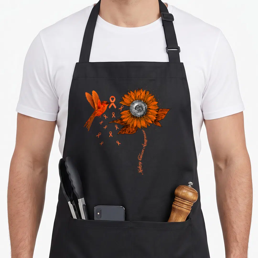 Hummingbird ribbon apron - Realistic sunflower and hummingbird with orange ribbons and vertical kidney cancer awareness — shown on a black cotton canvas apron against a white background