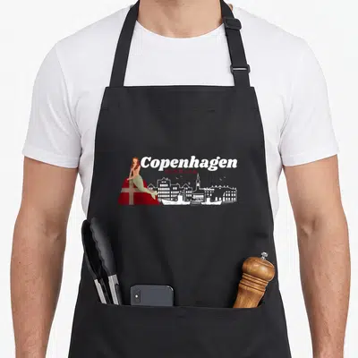 Copenhagen finnish girl apron - Cartoon mermaid on red flag next to white Copenhagen skyline and text — shown on a black cotton canvas apron against a white background