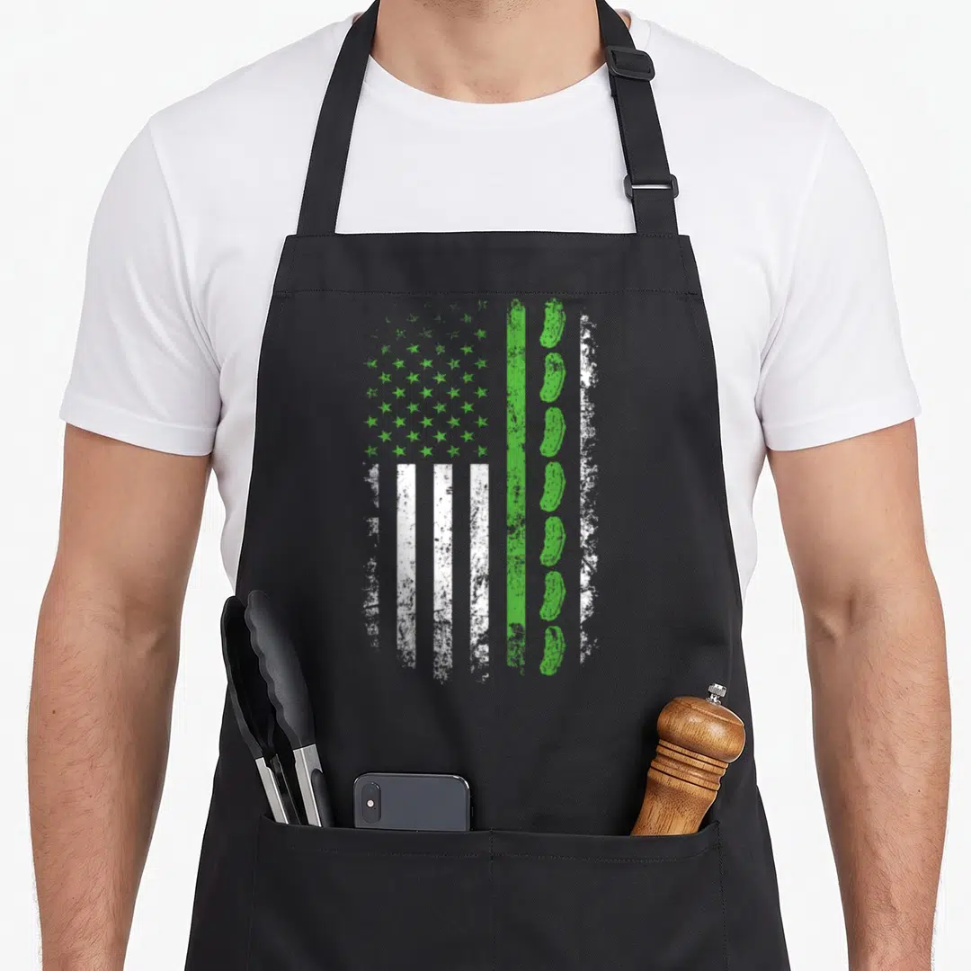 Pickle american flag apron - Distressed green and white flag with star canton and vertical cucumber column replacing — shown on a black cotton canvas apron against a white background