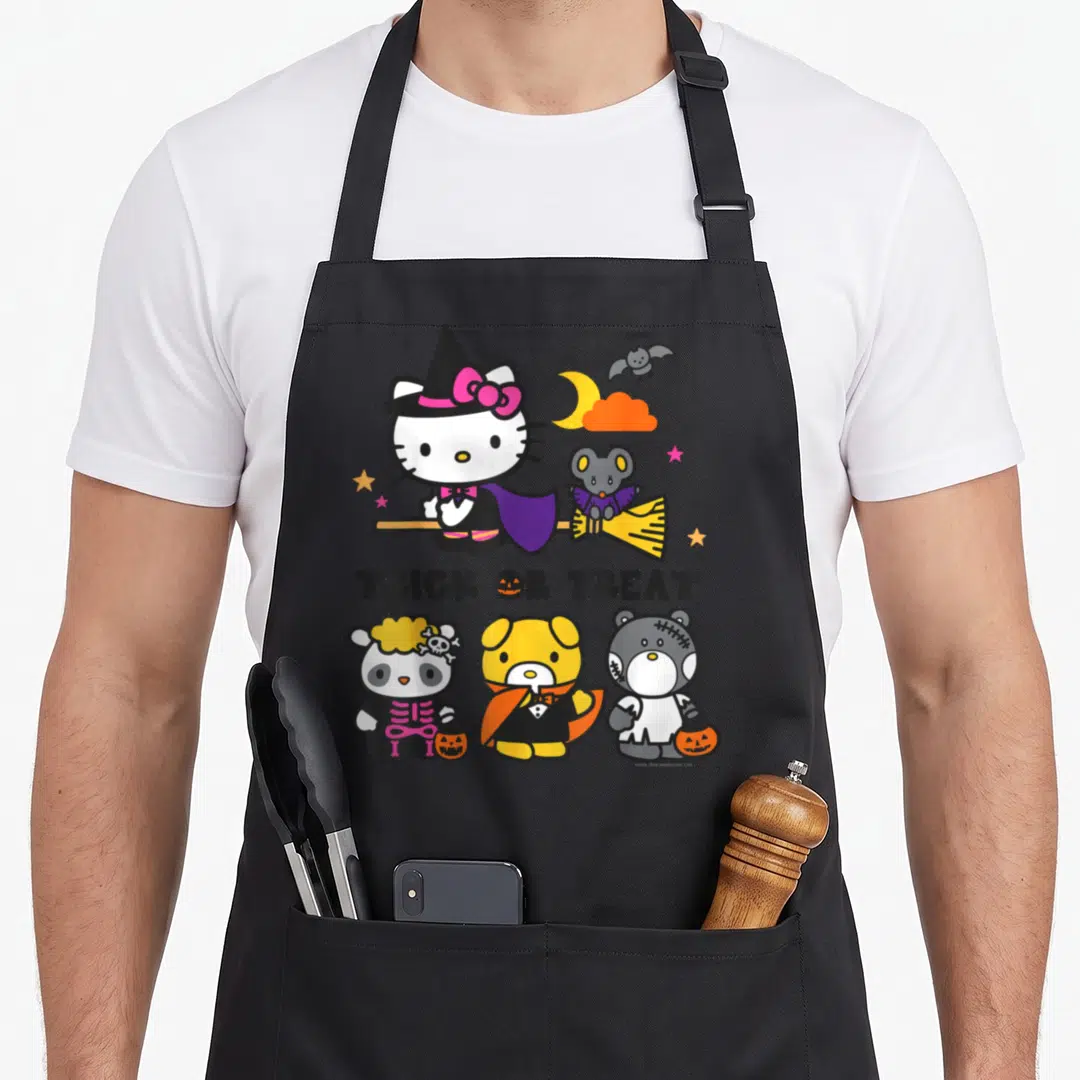Cute friend halloween apron - Hello Kitty on broom with Trick or Treat text and three costumed animal friends below — shown on a black cotton canvas apron against a white background