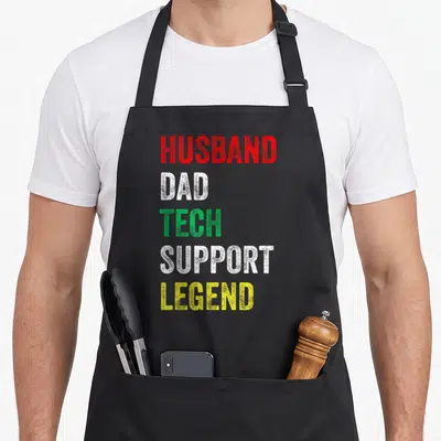 Tech husband apron - Stacked Husband Dad Tech Support Legend text in red white green and yellow — shown on a black cotton canvas apron against a white background
