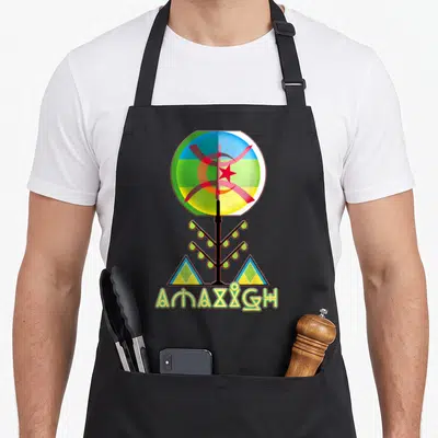 Amazigh tree aprons - Circular symbol with red star and crescent above stylized tree and two triangles — shown on a black cotton canvas apron against a white background