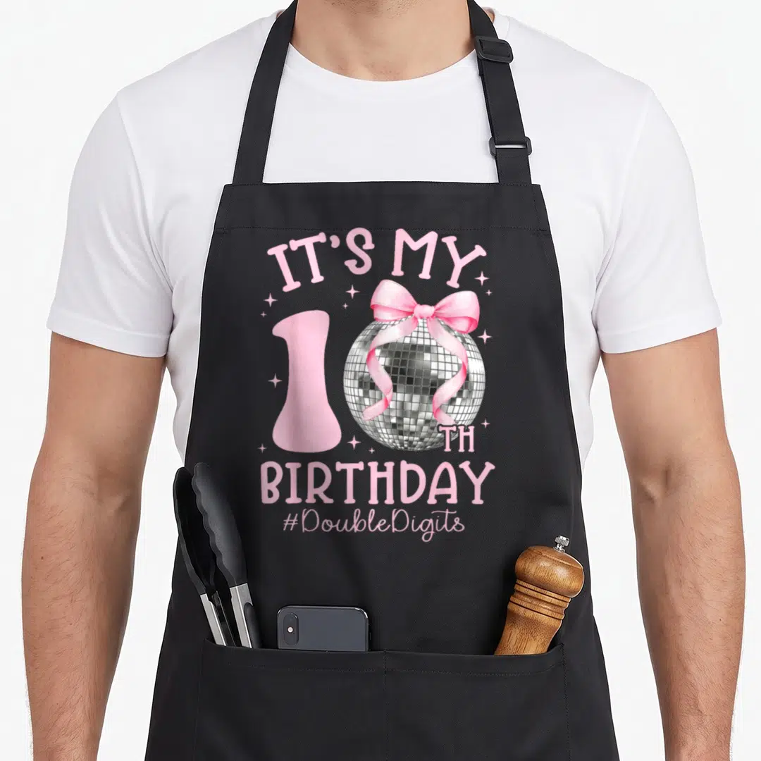 Birthday bow apron - Pink 10th birthday disco ball with pink bow and DoubleDigits text — shown on a black cotton canvas apron against a white background