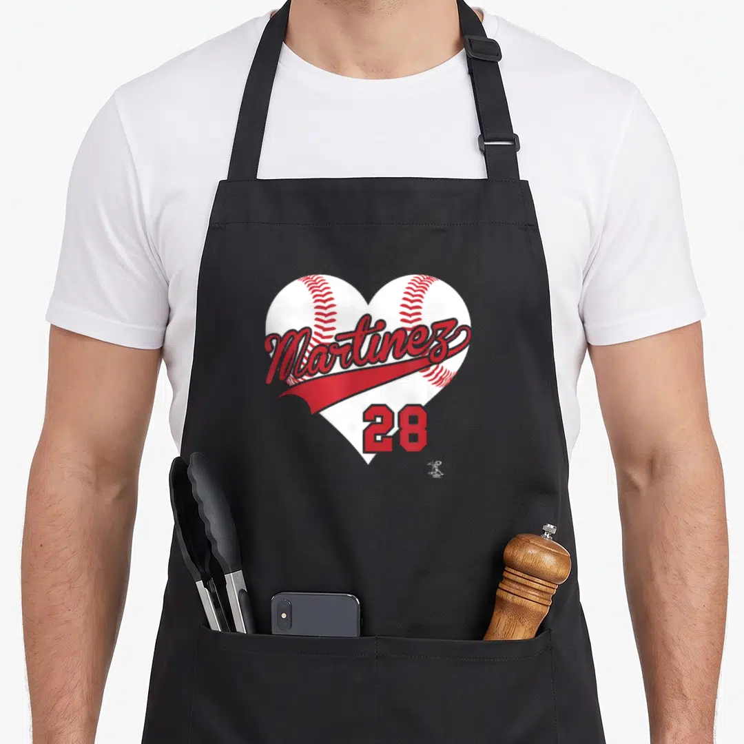 Gameday baseball apron - White heart shape made of two baseballs with red Martinez script and number 28 — shown on a black cotton canvas apron against a white background
