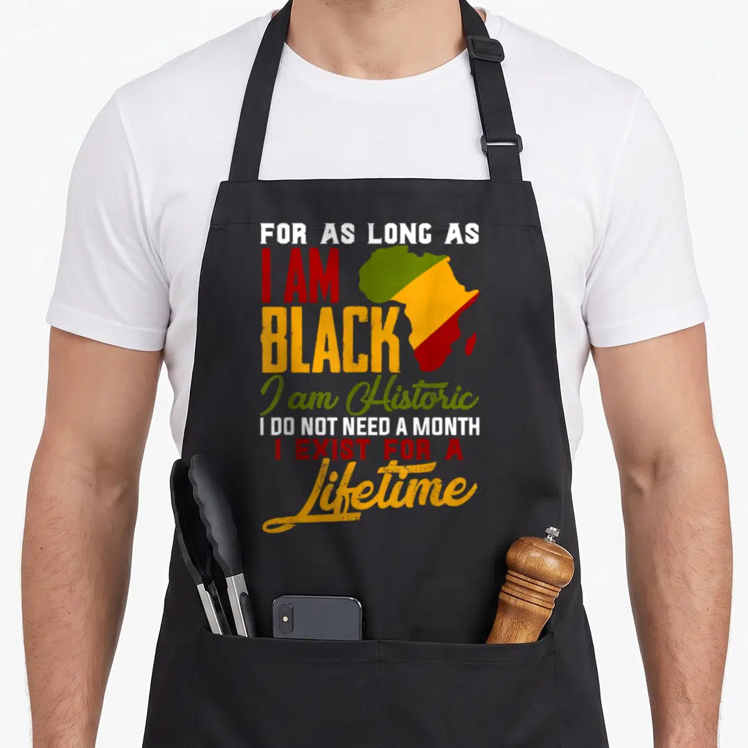 Lifetime history apron - Distressed map of Africa in green yellow red with text about Black history and lifetime — shown on a black cotton canvas apron against a white background