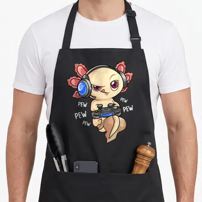 Kawaii video game apron - Peach axolotl with blue headphones holding controller surrounded by white PEW text — shown on a black cotton canvas apron against a white background