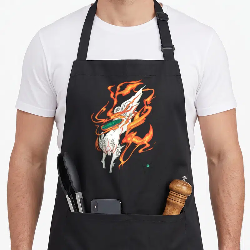 Sun video game apron - White fox surrounded by orange fire with a teal disk floating in front — shown on a black cotton canvas apron against a white background