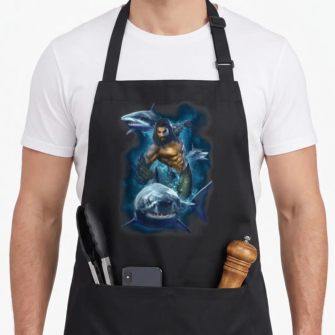 Movie pull girl apron - Realistic man swimming with three sharks in blue and tan water — shown on a black cotton canvas apron against a white background