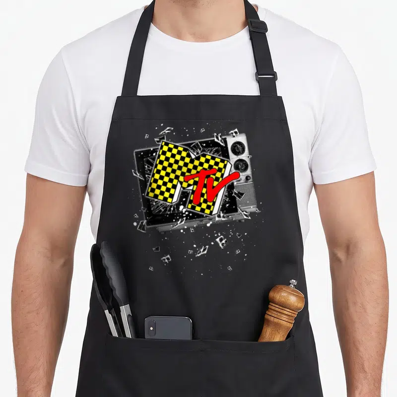 Checker mtv apron - Retro TV shattering with black yellow checkered logo and red TV text — shown on a black cotton canvas apron against a white background