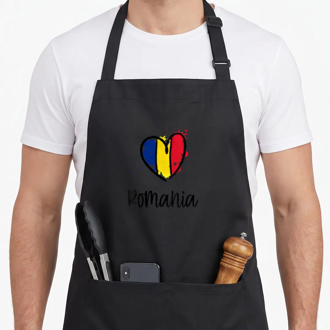 Europe romanian apron - Cartoon heart filled with blue yellow red flag colors above Romania text — shown on a black cotton canvas apron against a white background