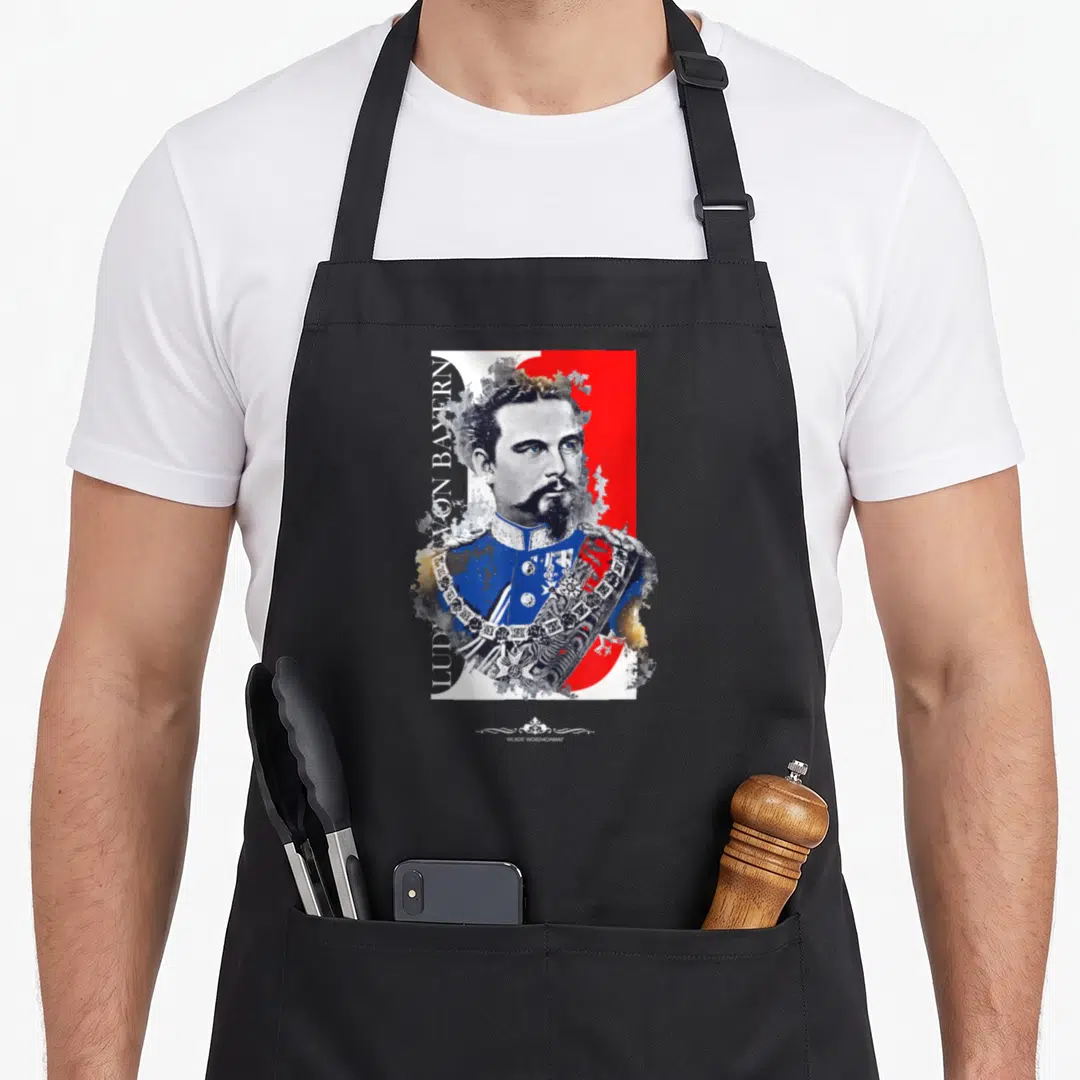 Ludwig king apron - Watercolor portrait of bearded man in blue uniform with vertical Ludwig Von Bayern text on red — shown on a black cotton canvas apron against a white background