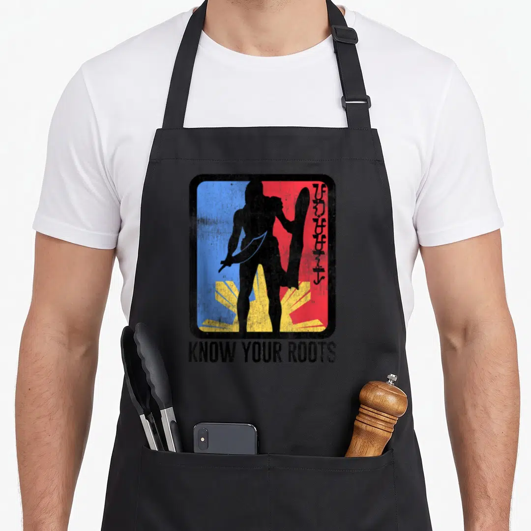 Lapu filipino pride apron - Warrior silhouette holding sword and shield over blue red yellow sun with KNOW YOUR ROOTS — shown on a black cotton canvas apron against a white background