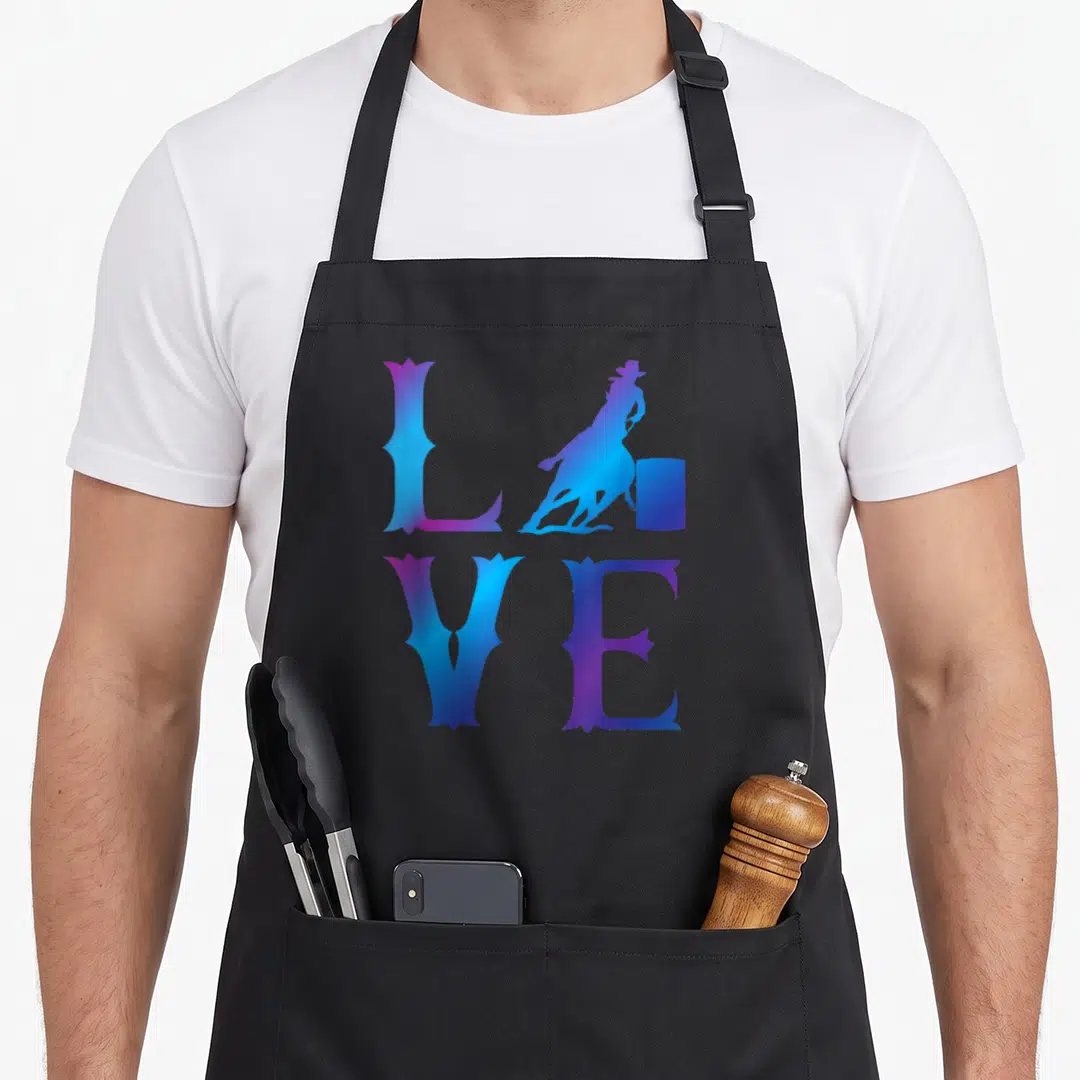 Rodeo racing apron - Stylized LOVE text with purple blue gradient and barrel racing silhouette replacing the letter O — shown on a black cotton canvas apron against a white background