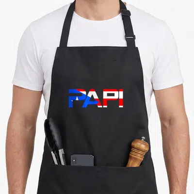 Papi dad mode apron - PAPI text filled with blue red and white flag stripes — shown on a black cotton canvas apron against a white background