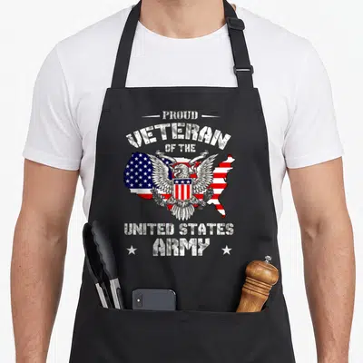 Proud us aprons - Distressed text Proud Veteran United States Army above and below eagle on US flag map — shown on a black cotton canvas apron against a white background