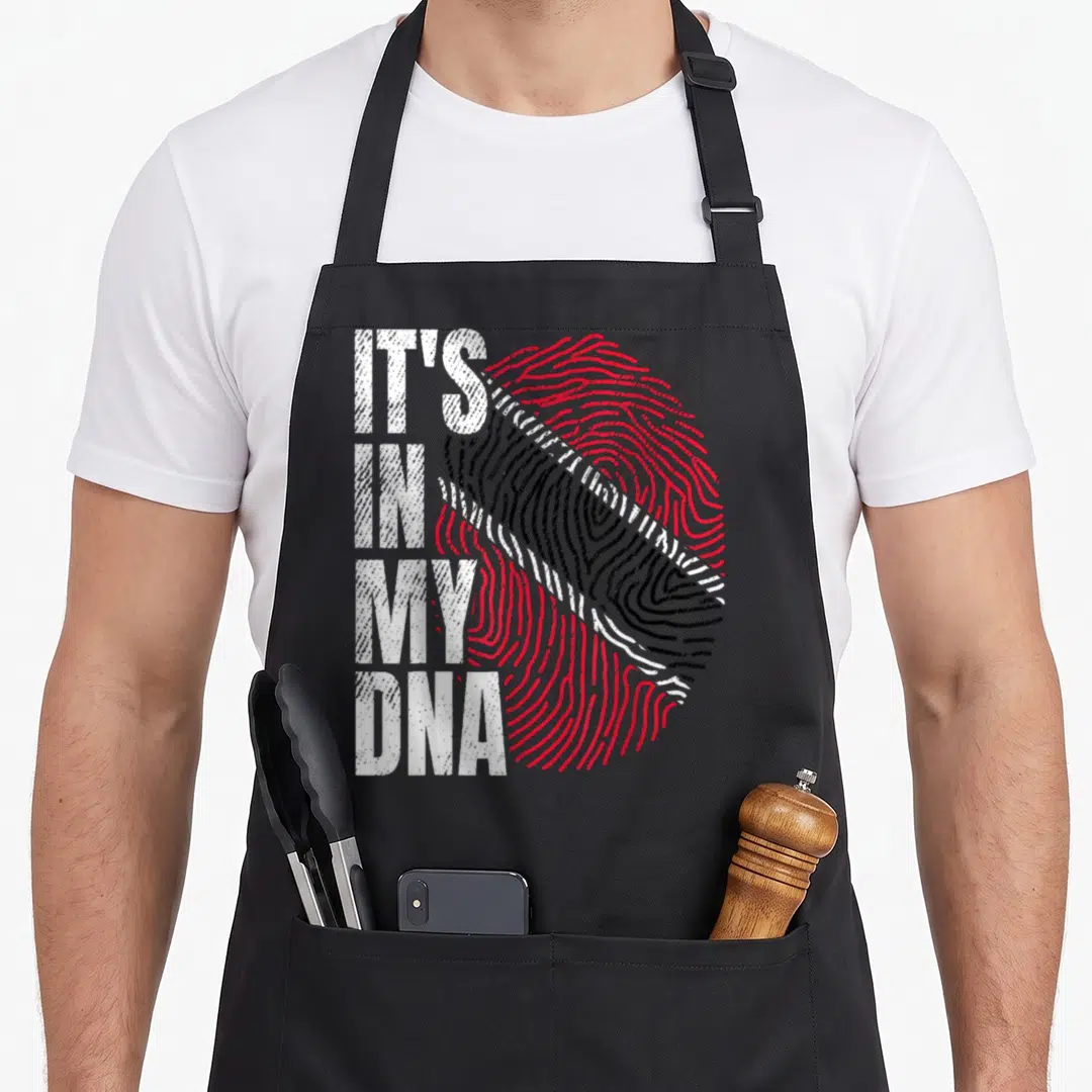 Dna trinidadian girl apron - Distressed fingerprint in red black and white with stacked text It's in My DNA — shown on a black cotton canvas apron against a white background