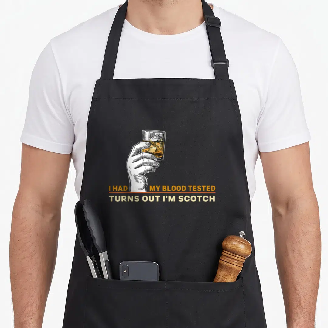 Tested blood apron - Hand holding scotch glass with I Had My Blood Tested Turns Out I'm Scotch text — shown on a black cotton canvas apron against a white background