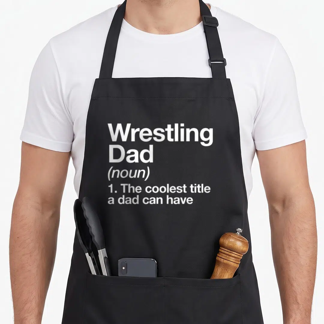 Sport wrestling apron - White stacked text defining Wrestling Dad as the coolest title a dad can have — shown on a black cotton canvas apron against a white background