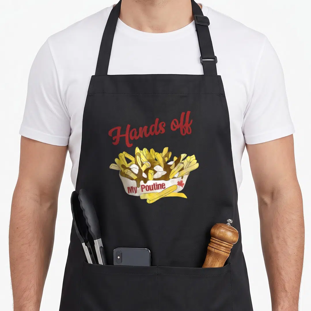 Hand canadian aprons - Watercolor poutine bowl with red Hands off text and small maple leaf — shown on a black cotton canvas apron against a white background