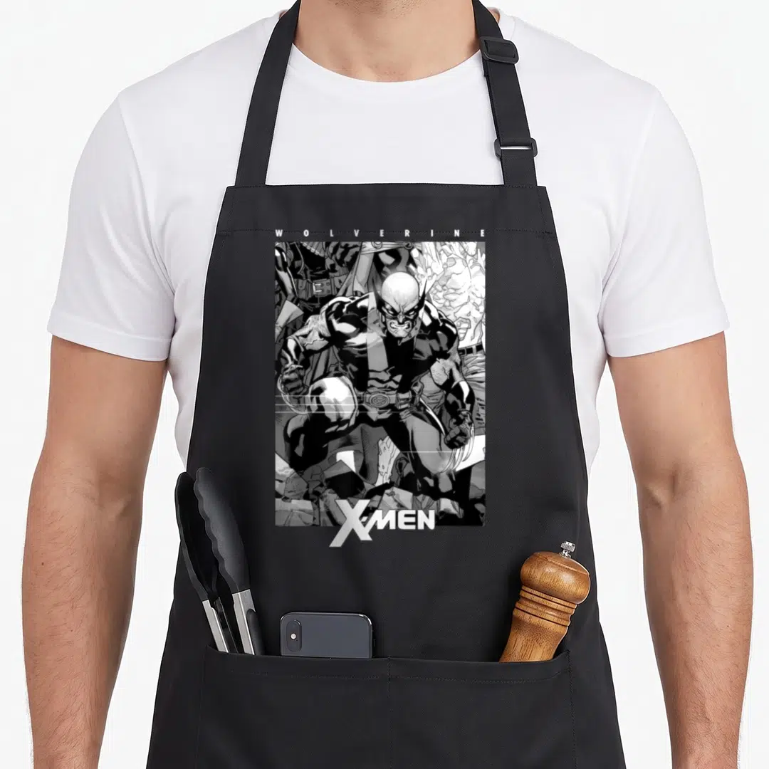 Comic x apron - Black and white line art of Wolverine with WOLVERINE and X-MEN text — shown on a black cotton canvas apron against a white background
