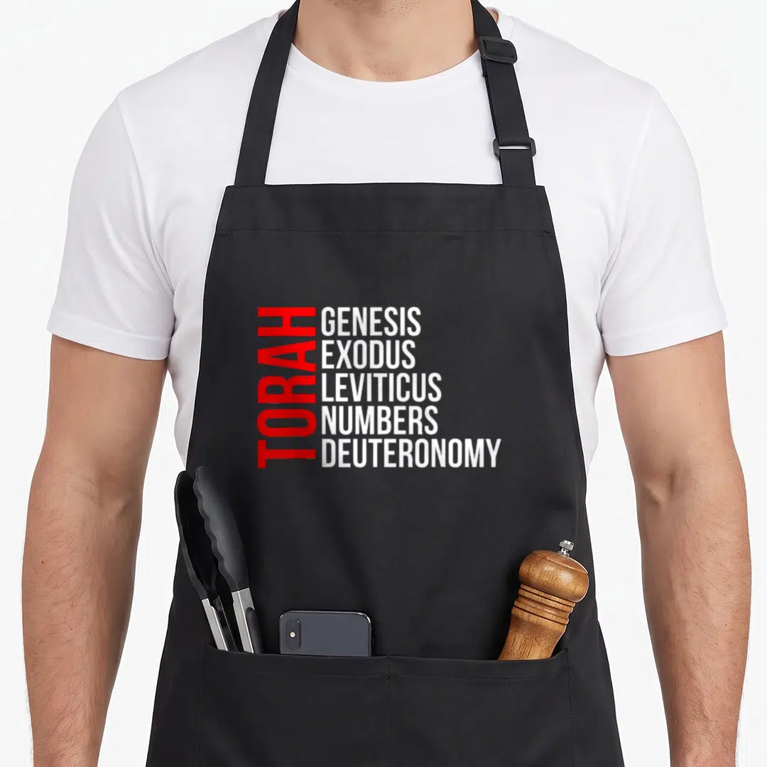 Book hebrew aprons - Red vertical TORAH text beside stacked white Genesis Exodus Leviticus Numbers Deuteronomy — shown on a black cotton canvas apron against a white background