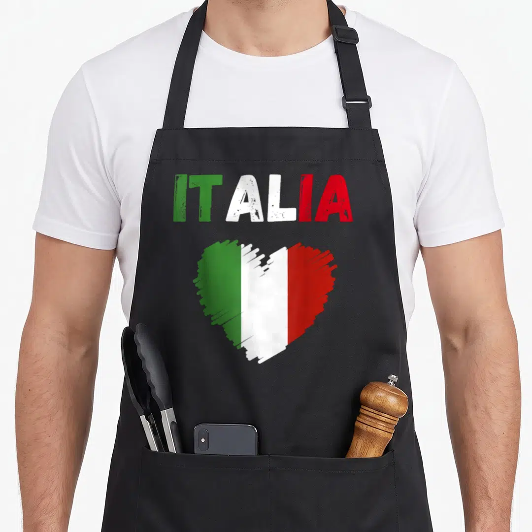 Patriotic italy apron - ITALIA text and heart filled with green white and red vertical stripes — shown on a black cotton canvas apron against a white background