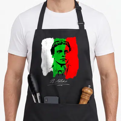 Vasil holiday apron - Man silhouette over distressed white green red tricolor with V. Abckii script — shown on a black cotton canvas apron against a white background
