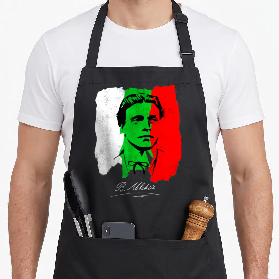 Vasil holiday apron - Man silhouette over distressed white green red tricolor with V. Abckii script — shown on a black cotton canvas apron against a white background