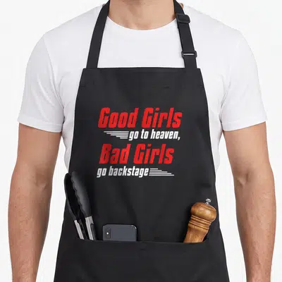 Heaven goer apron - Red and white text Good Girls go backstage with speed lines on black fabric — shown on a black cotton canvas apron against a white background